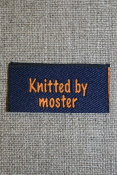 Blå/orange mærke "Knitted by moster"